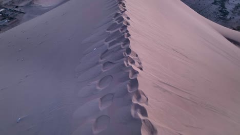 woman walking by sand dune