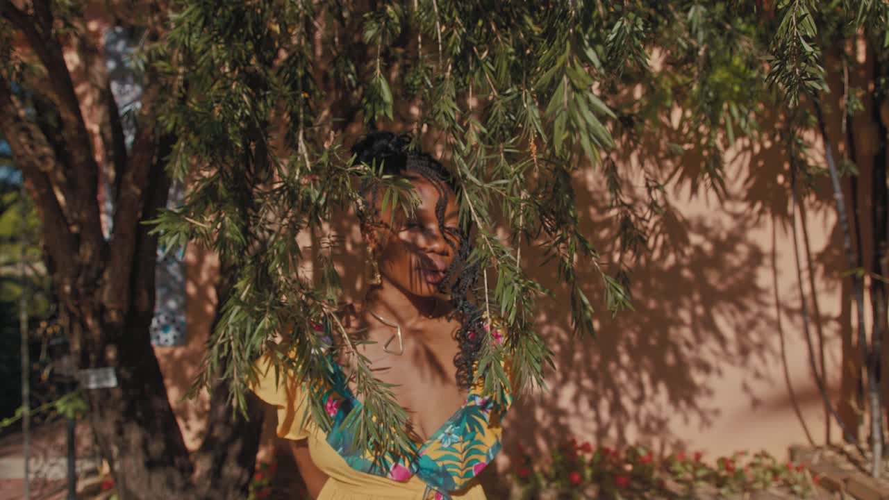 Woman in a yellow dress, hidden behind trees