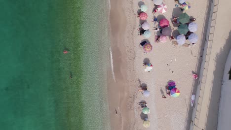 Top-down-aerial-over-white-sand-beach-and-crystal-clear-water,-Himarë,-Albania