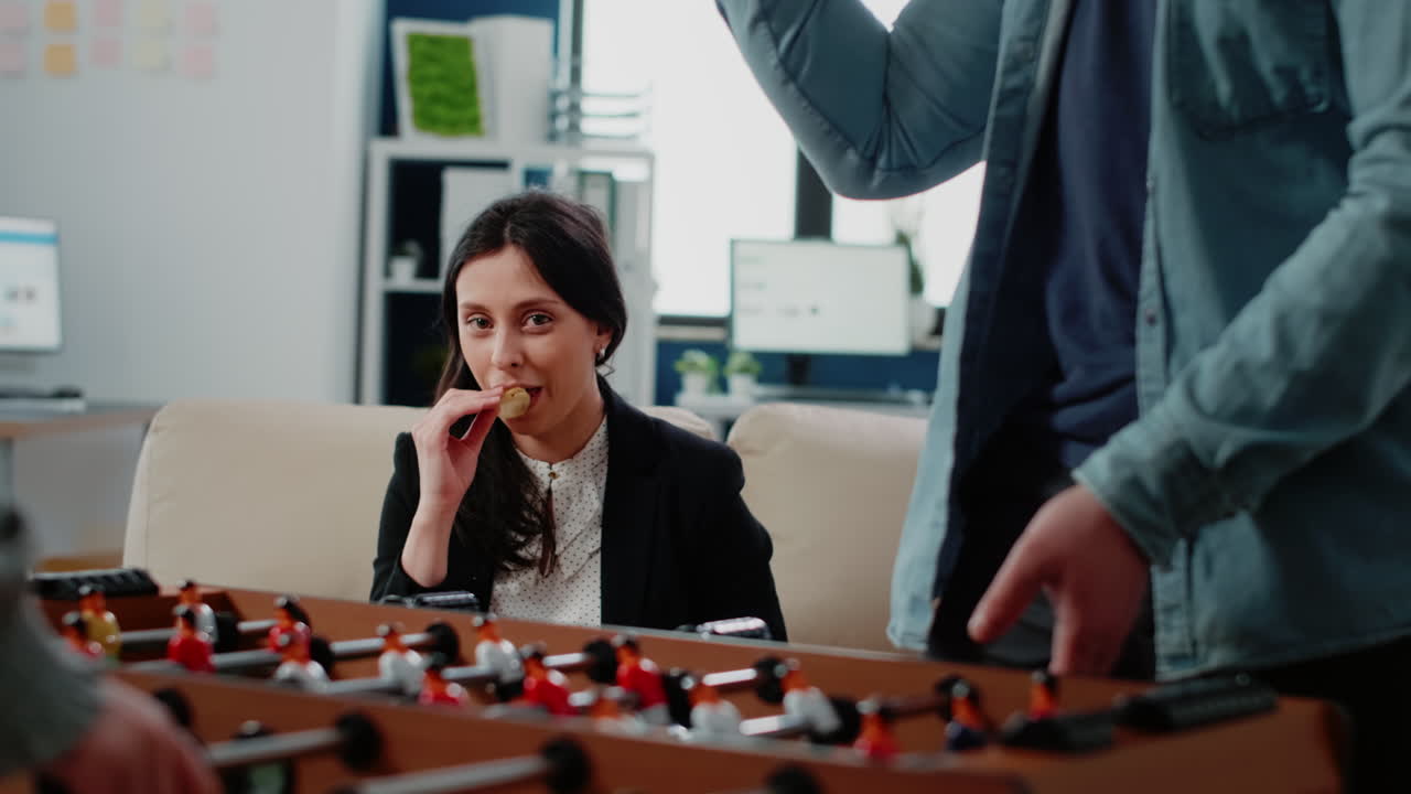 Portrait of businesswoman looking at foosball game table