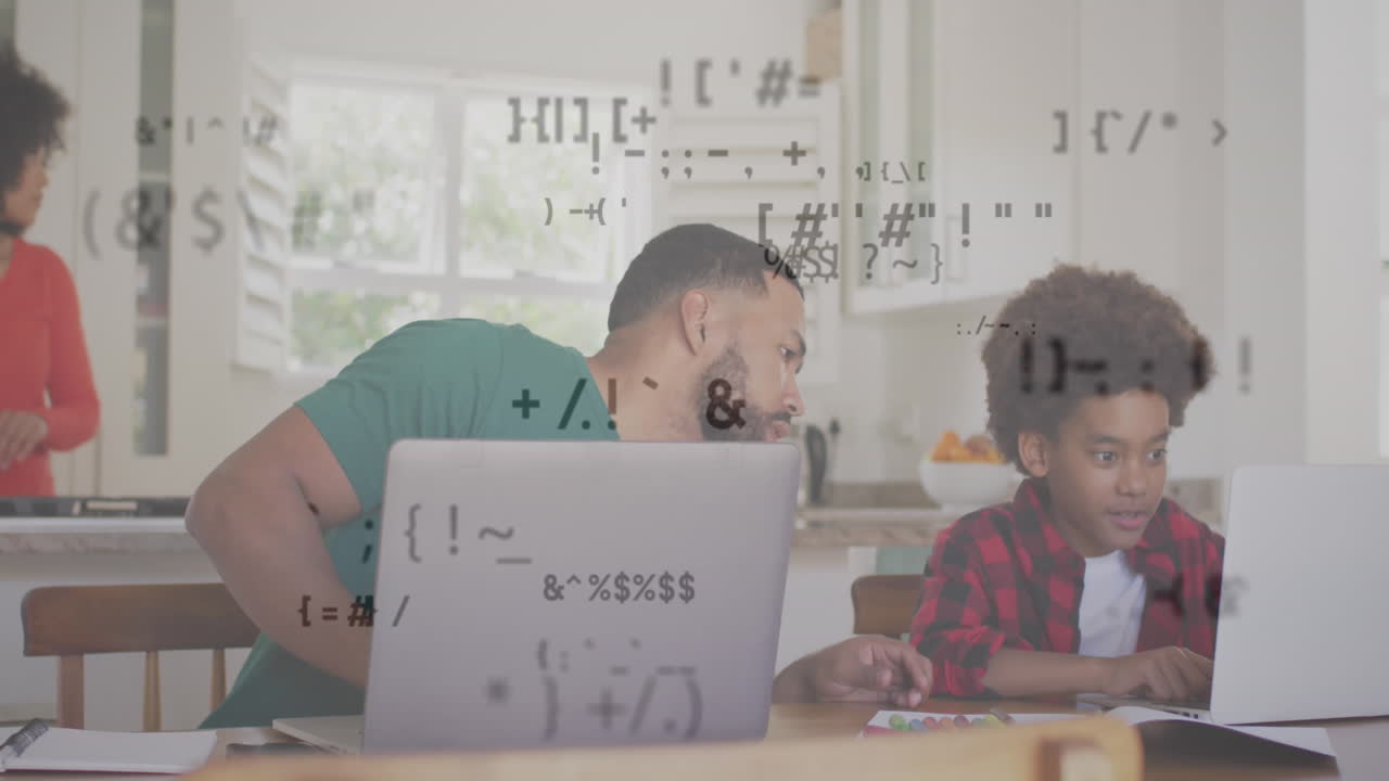 Animation of multiple symbols over diverse father helping son in using laptop at home