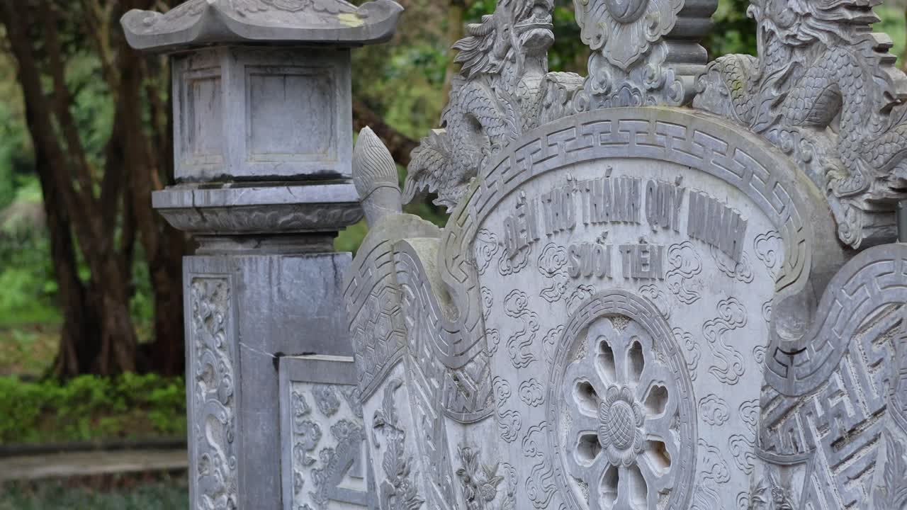 Detailed carvings on a historic Vietnamese tombstone
