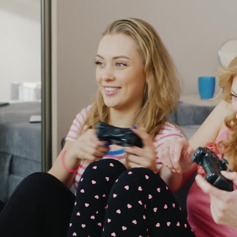 two young women playing on the console 1