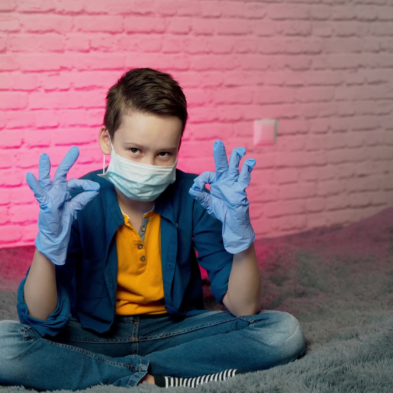 Boy isolated, stay at home in protective sterile medical mask on face and gloves. Quarantine, prevent infection. Stop coronavirus. Stay at home