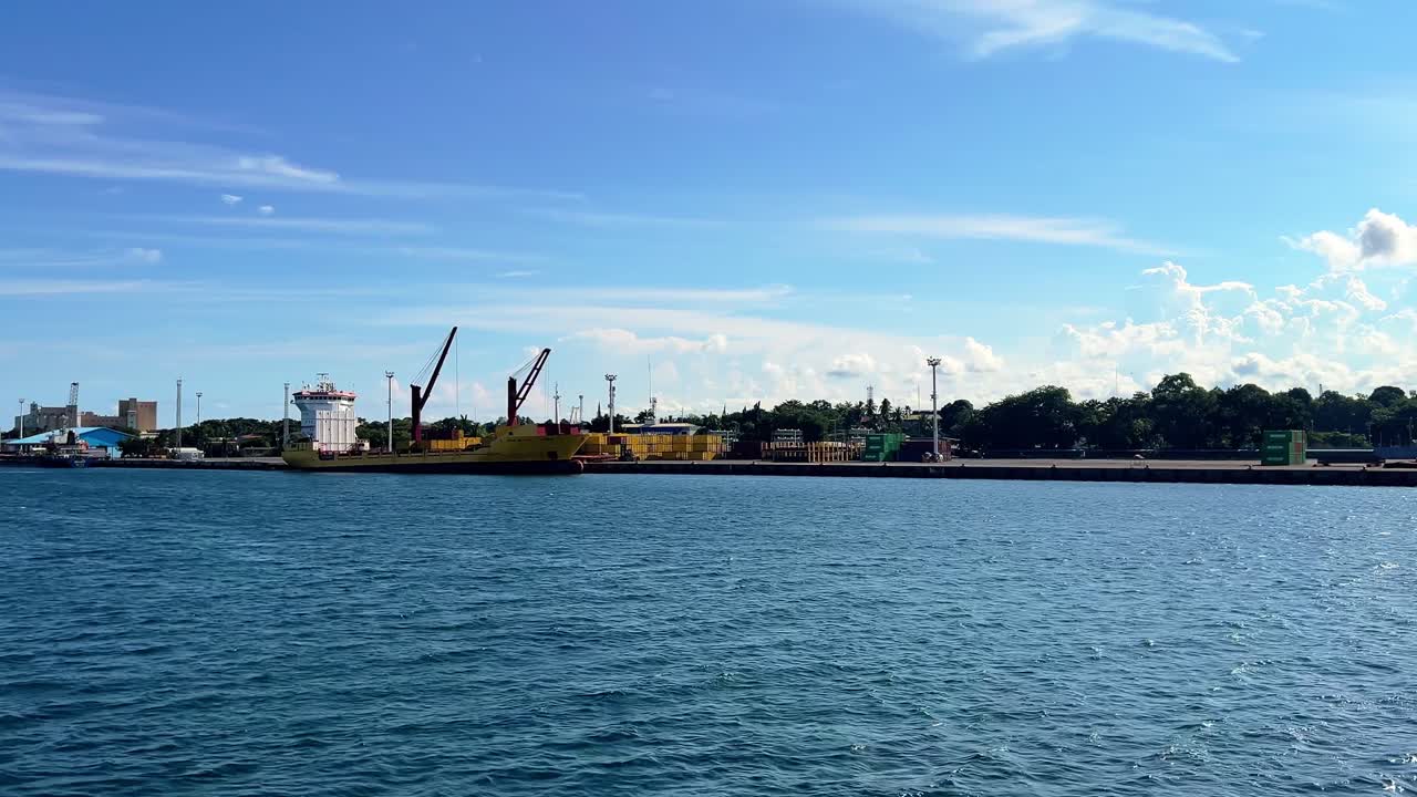 Industrial shipping dock with cranes, containers, and vessel on calm sea—perfect for logistics, industry, or transportation themes