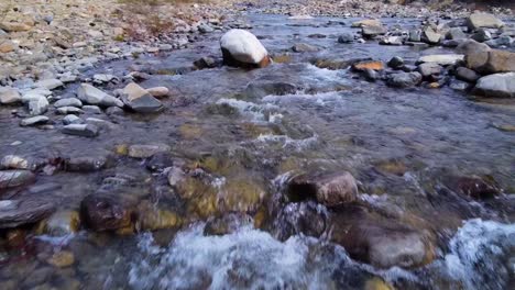 flying up to the river in aragües del puerto, the spanish pyrenees, going close to the water and rocks