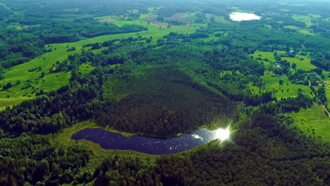 latvian landscape lake reflecting sunslight, aerial view, latvia