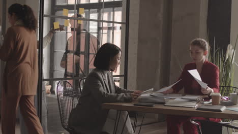 female managers reading documents in office