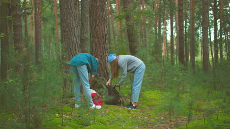 young hikers zip up their bags in a lush forest, preparing for their hike, securely close their bags, hang over their shoulders, and ready themselves to continue hiking