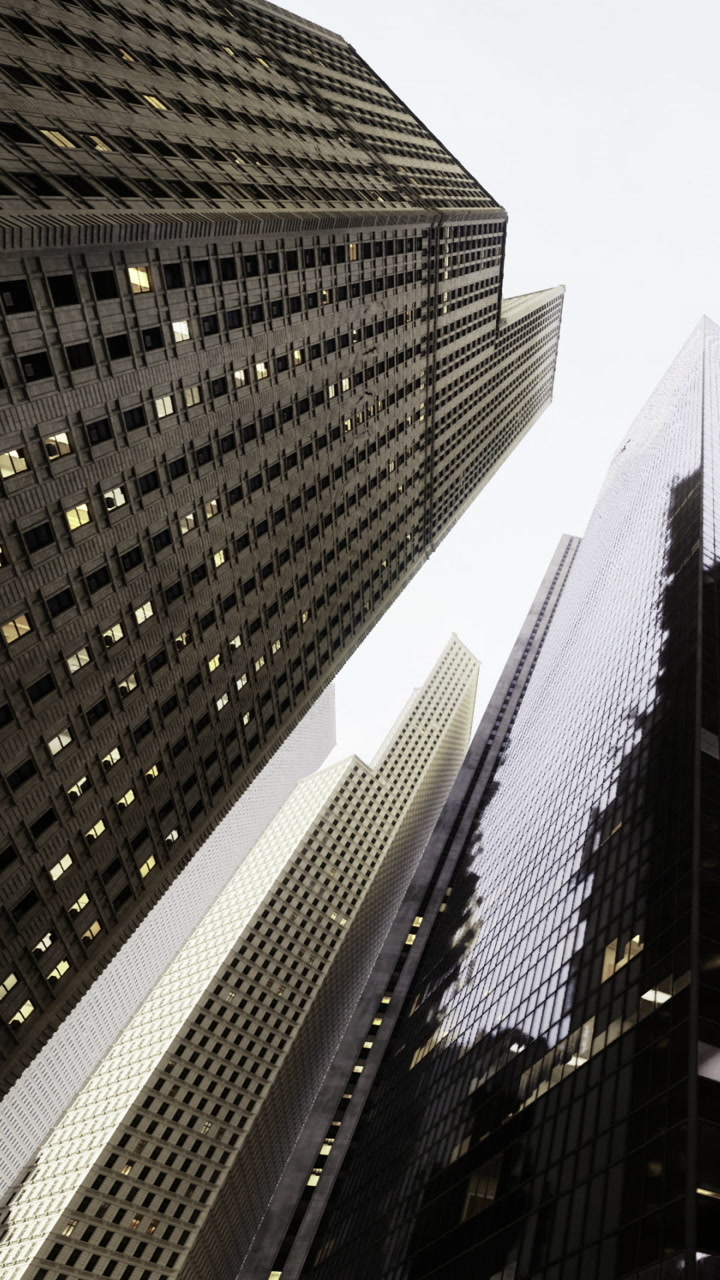 Skyscrapers reach for the sky in a bustling urban landscape at dusk