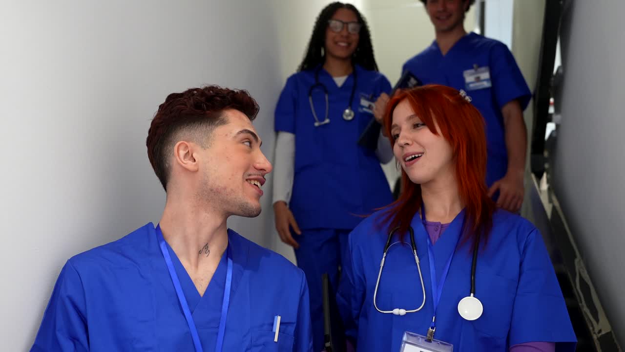 Happy Medical Students Walking and Talking Down Hospital Stairs