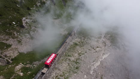 aerial view of niesen funicular railway riding through scenic swiss landscape