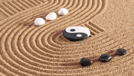 japanese zen garden with yin yang stones in textured sand