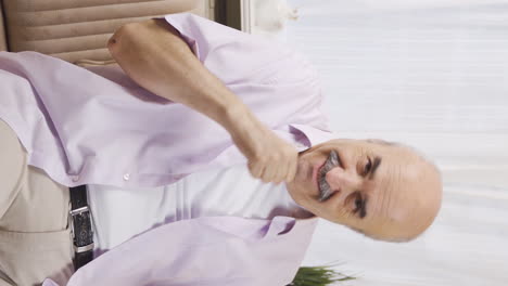 Vertical-video-of-Happy-old-man-dancing-to-the-camera.