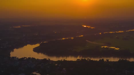 Golden-sunset-over-Bangladesh-landscape-and-Sylhet-river,-timelapse-zoom-in-view