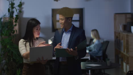 Asian-woman-and-biracial-man-discuss-business-work-in-a-modern-office