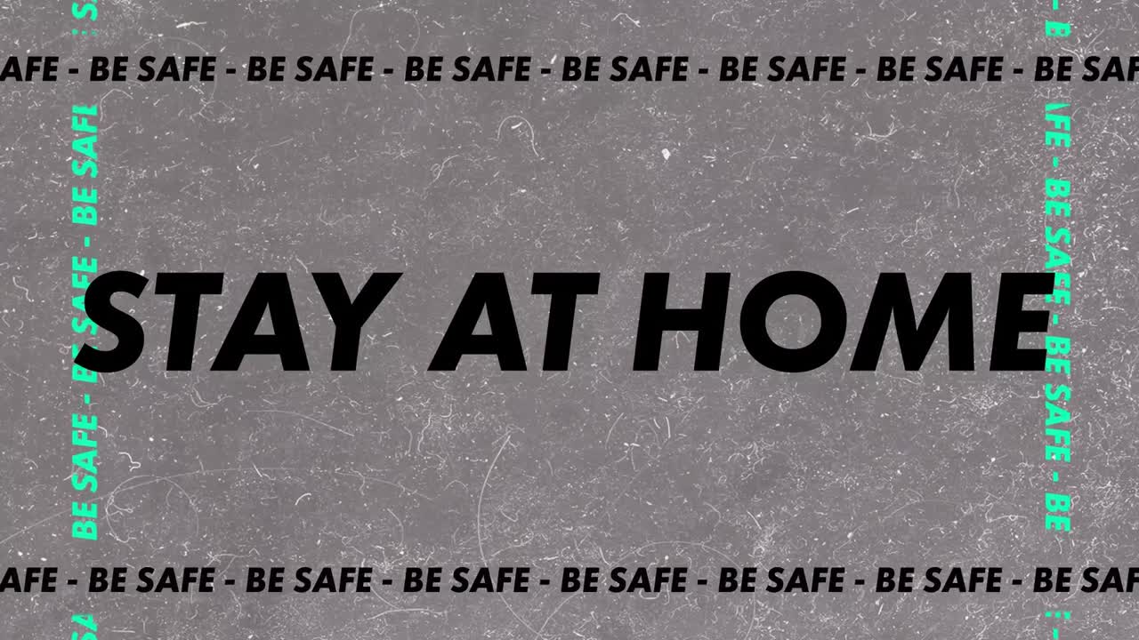 "안전해라, 집에 있어라"라는 단어가 회색 바탕에 검은색과 초록색 글자로 쓰여져 있습니다.