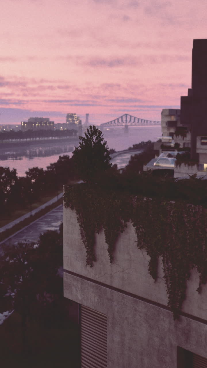 Vibrant sunset reflects on calm river with modern architecture nearby