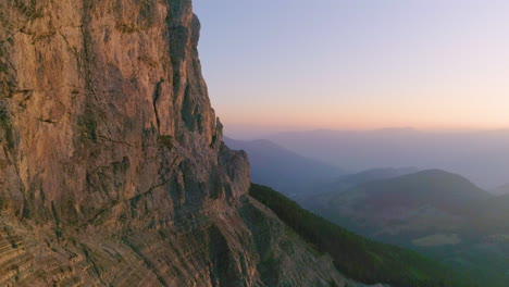 South-Tyrol-Plose-Peitlerkofel-golden-hour-steep-mountain-slope-aerial-view-looking-out-to-spectacular-hazy-valley-vista