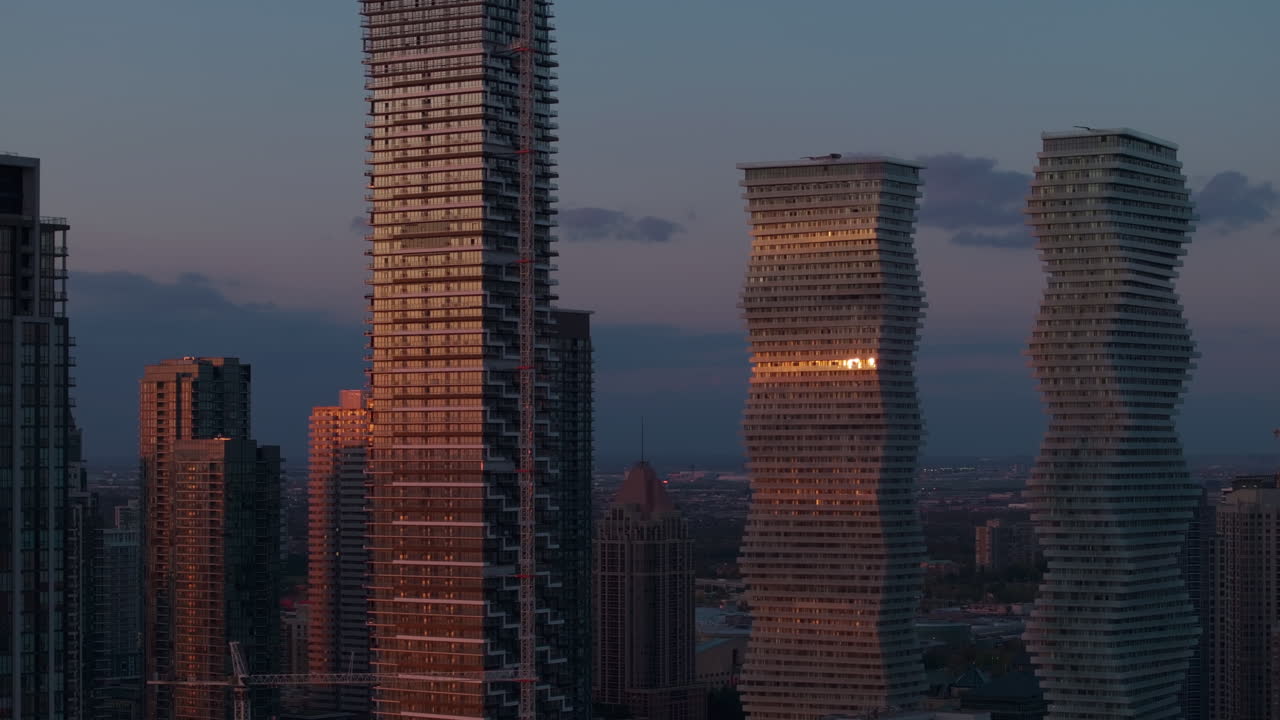 Sunrise over modern condos in Mississauga's urban skyline