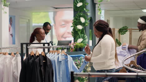 Client-checks-shirt-quality-in-mall