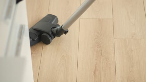 vacuuming a wooden floor