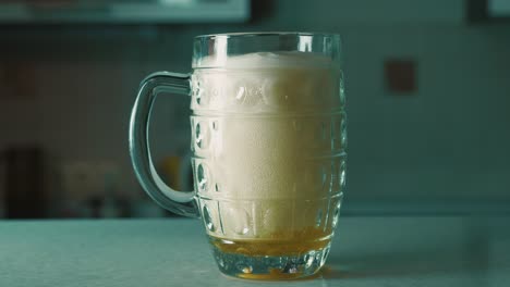 pouring beer into a glass mug