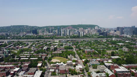 flying over petite-bourgogne, toward shaughnessy village, summer in montreal - aerial view