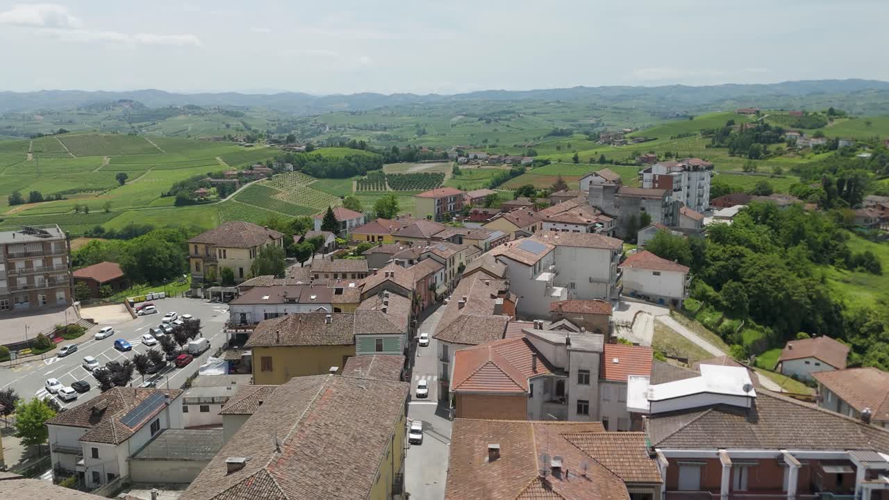 Agliano Terme, Asti, Piedmont, Italy. 4k aerial view of the town. Langhe-Roero and Monferrato. Flying forward above the town into the green vineyards