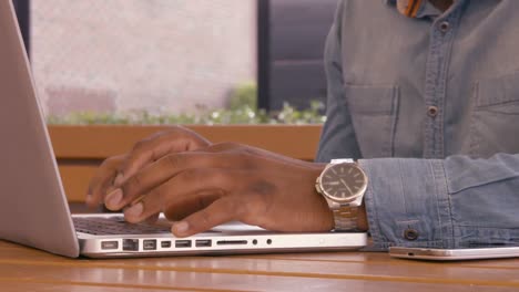 mans hands using laptop