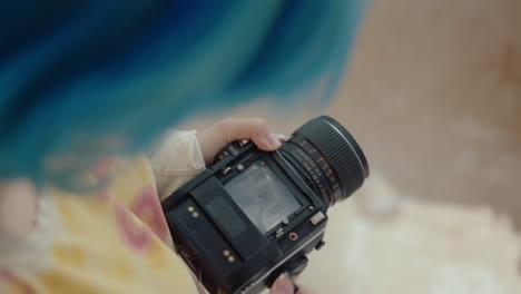 girl photographing boyfriend with vintage camera