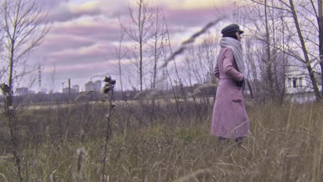 woman walking through a field in autumn