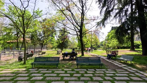 people walking in a sunny milan park