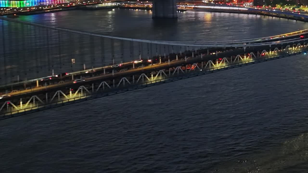 Colorful lights illuminate bridges in New York City during night