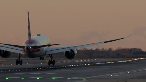 airplane landing at sunset