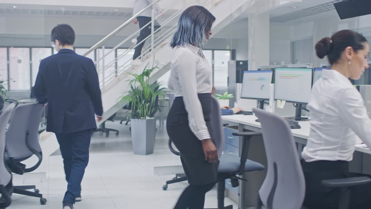 Diverse Multinational Team of Business Managers and Specialists Work on Desktop Computers, Have Discussion with Colleagues. Young and Motivated Business people in Modern Open Office.