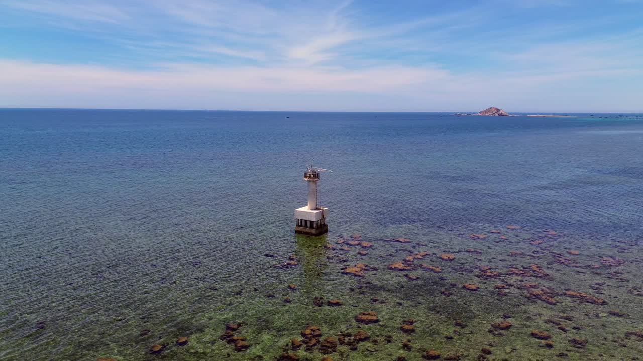 Semi orbit aerial view capturing the vivid coral textures and turquoise waters of My Hoa Lagoon in Phan Rang, Vietnam.