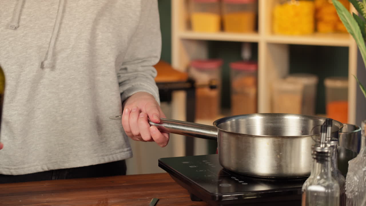 Close-up of Hands Pouring Red Wine into Saucepan for Cooking