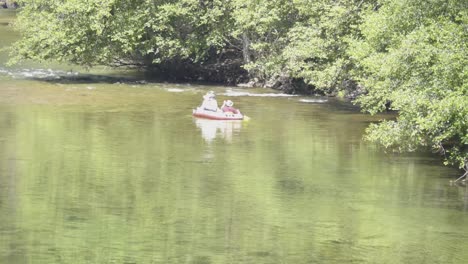 people on a boat heading towards rapids