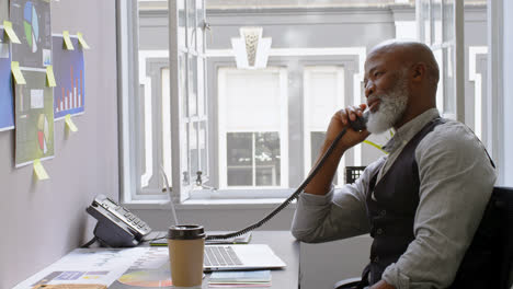 businessman talking on landline at desk 4k