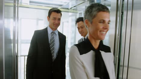 Business-people-getting-out-of-the-elevator-in-office-4k