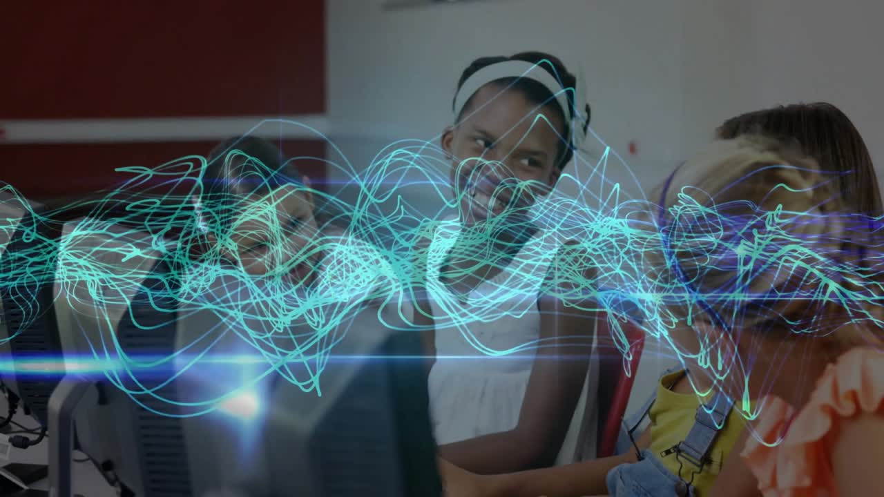 Four girls leaning forward in lab for collaboration while teal waveform undulates on monitors