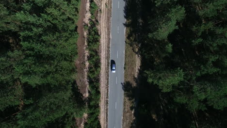 Copter-view-car-driving-to-countryside.-Drone-flying-over-car-over-woods