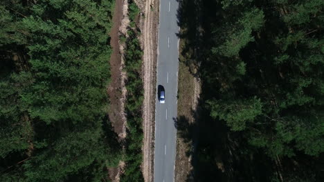 copter view car driving to countryside. drone flying over car over woods