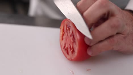 chef slicing a tomato