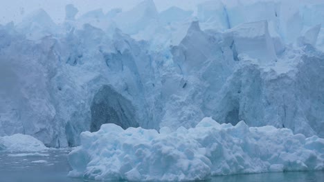 massive glacier and icebergs in polar waters
