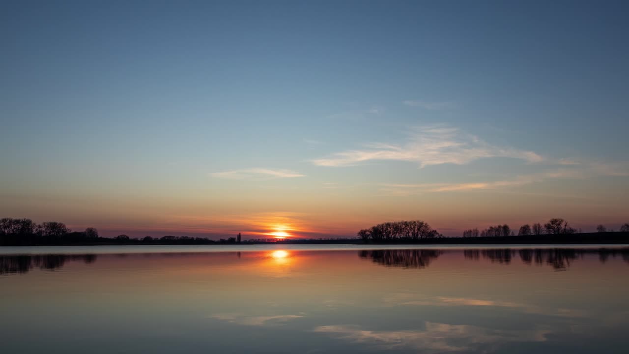 Sunset Timelapse Over a Glassy Calm Lake