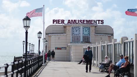 people walking and relaxing on worthing pier