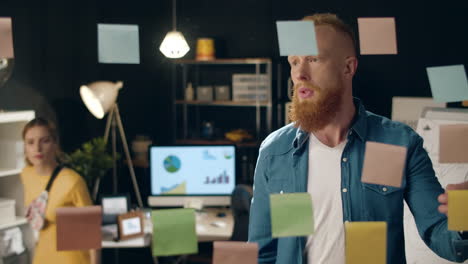 Puzzled-guy-asking-female-colleague-for-advice-in-business-hipster-office.