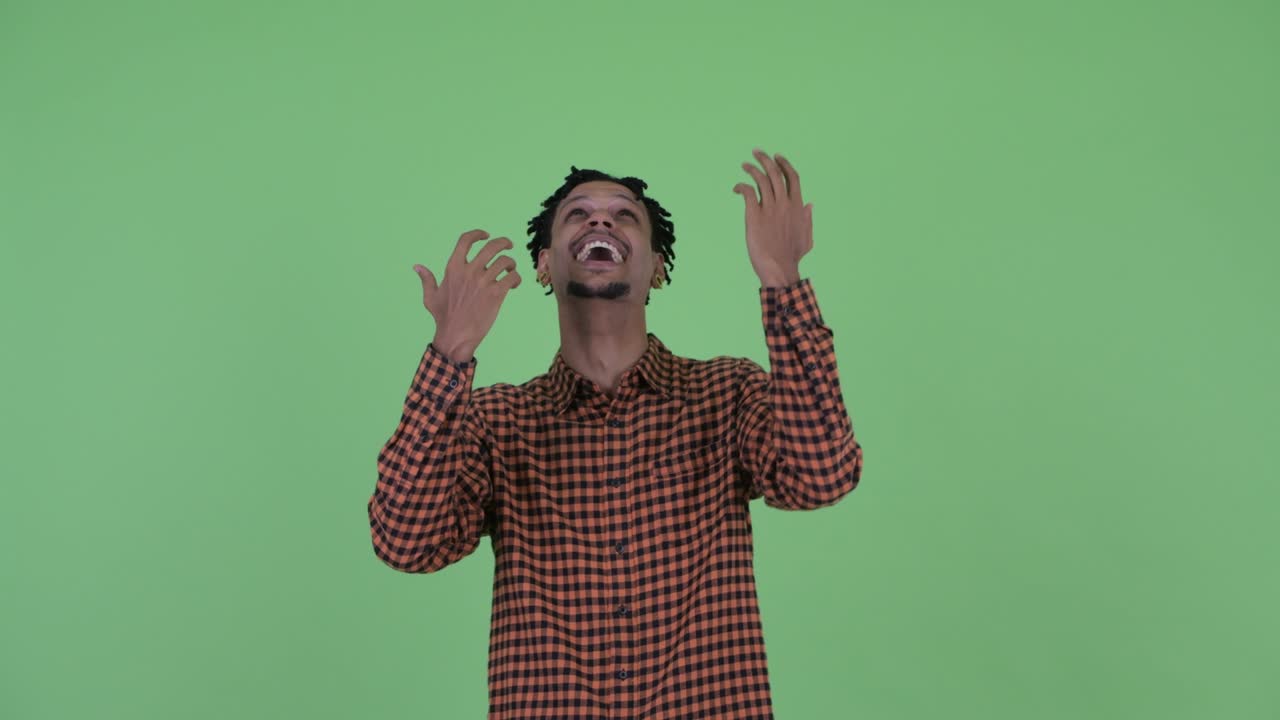 Happy young handsome African man with dreadlocks